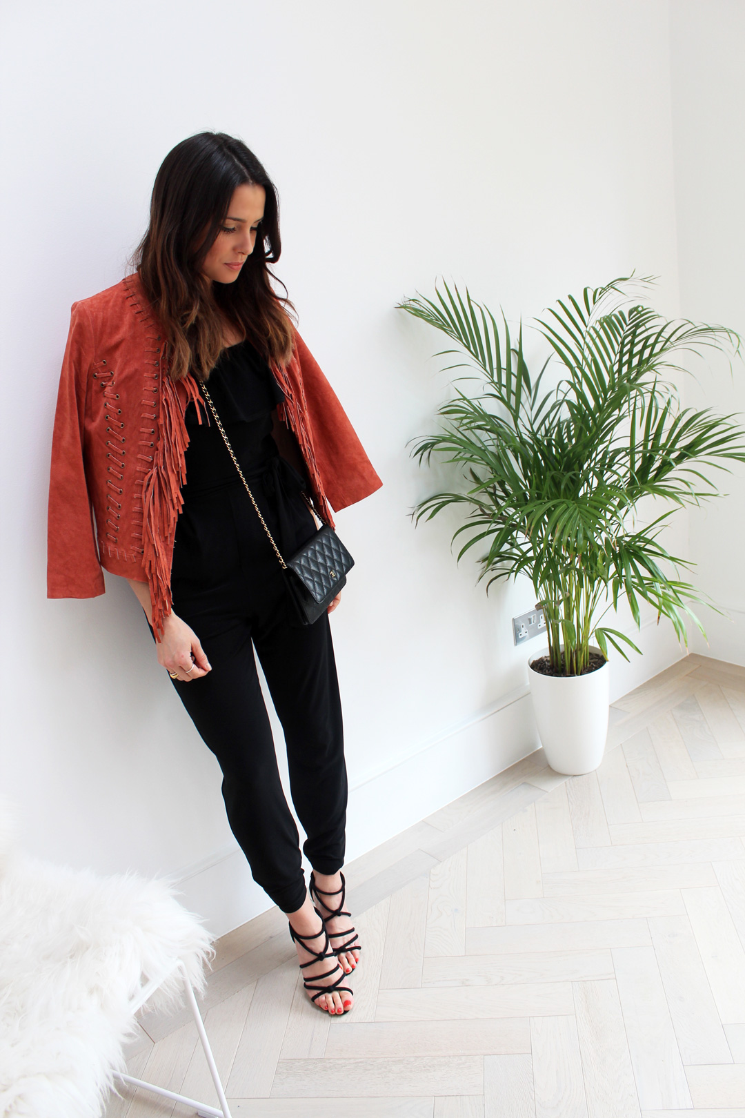 black jumpsuit with leather jacket